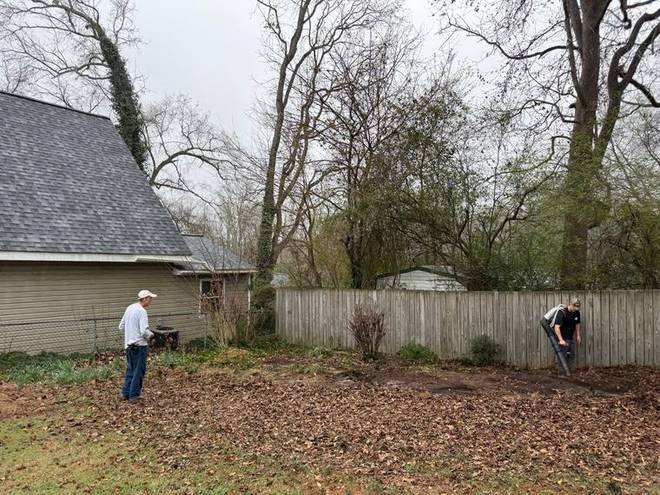 Before: a bare back yard covered in leaves and packed dirt.
