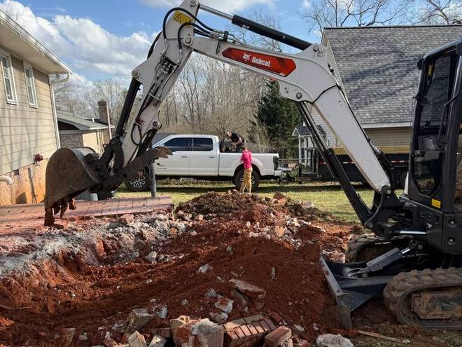 An excavator moving earth during a site preparation job.