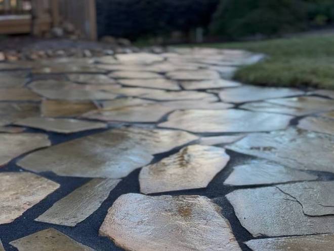 Close detail of a laid flagstone patio surface with tight joints.