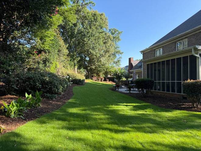 A maintained rear lawn with a clean bed edge along the boundary.