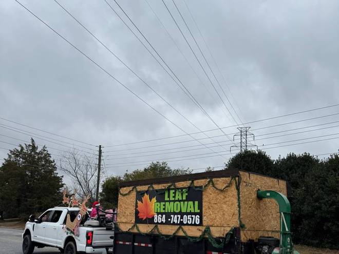 The company leaf vacuum truck parked on a residential street.