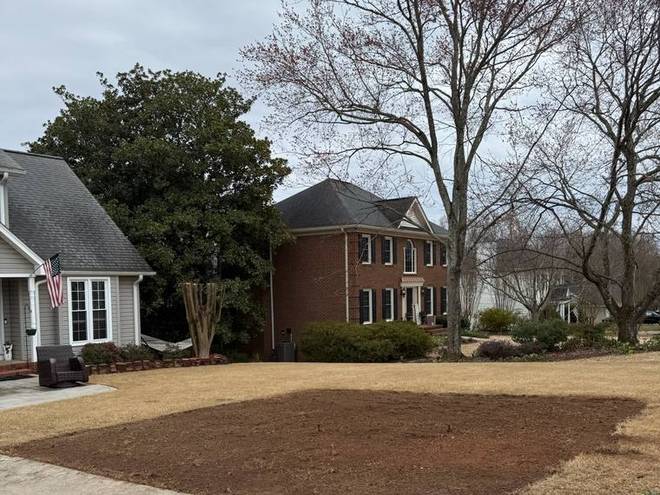 Bare graded ground in front of a home, ready for turf.