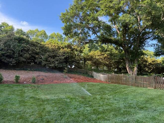 A sprinkler running on newly laid turf.