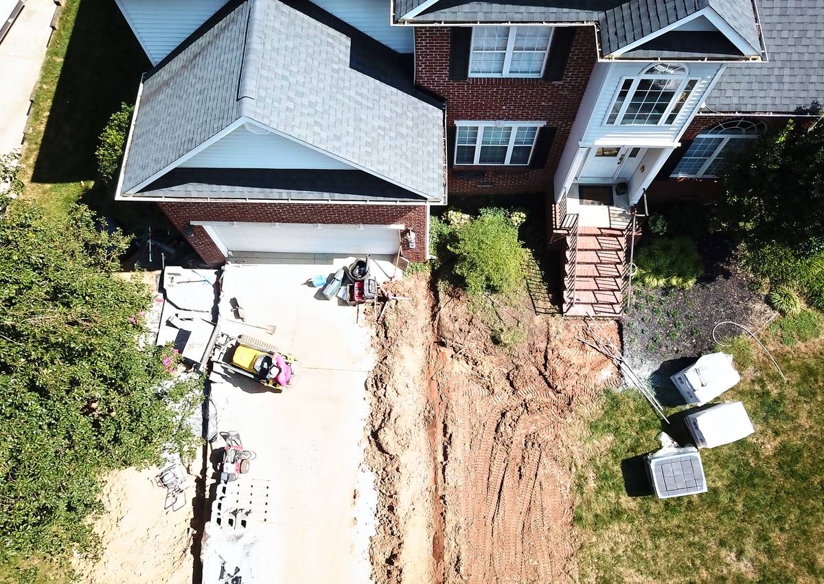 A trench running along the side of the house.