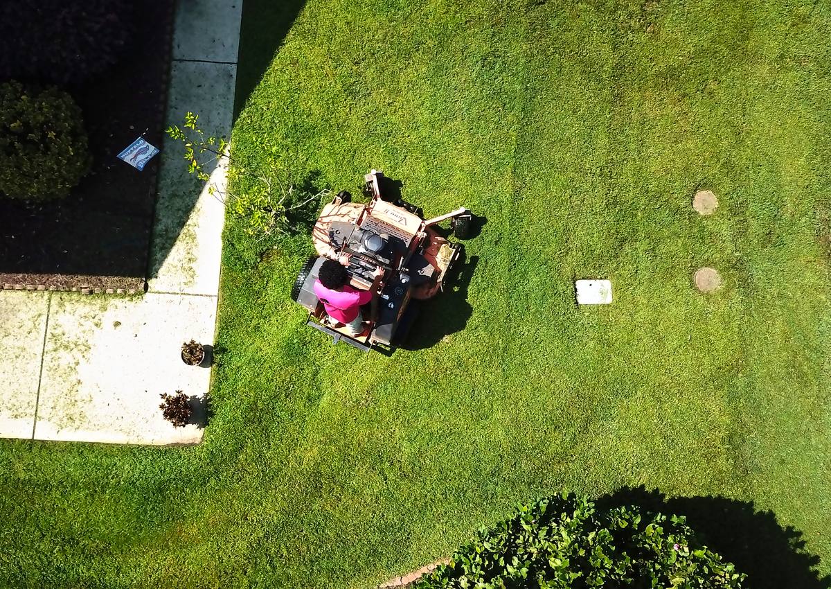 Overhead view of a stand-on mower cutting clean lines.