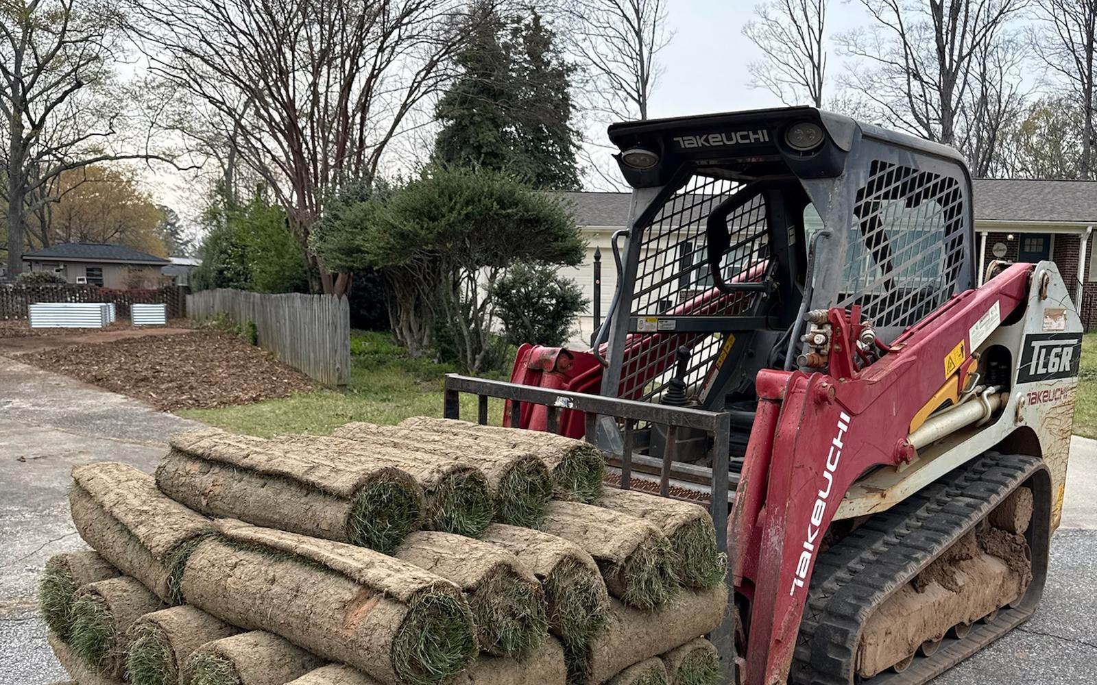 Pallets of fresh sod loaded on a track loader ready to be laid.